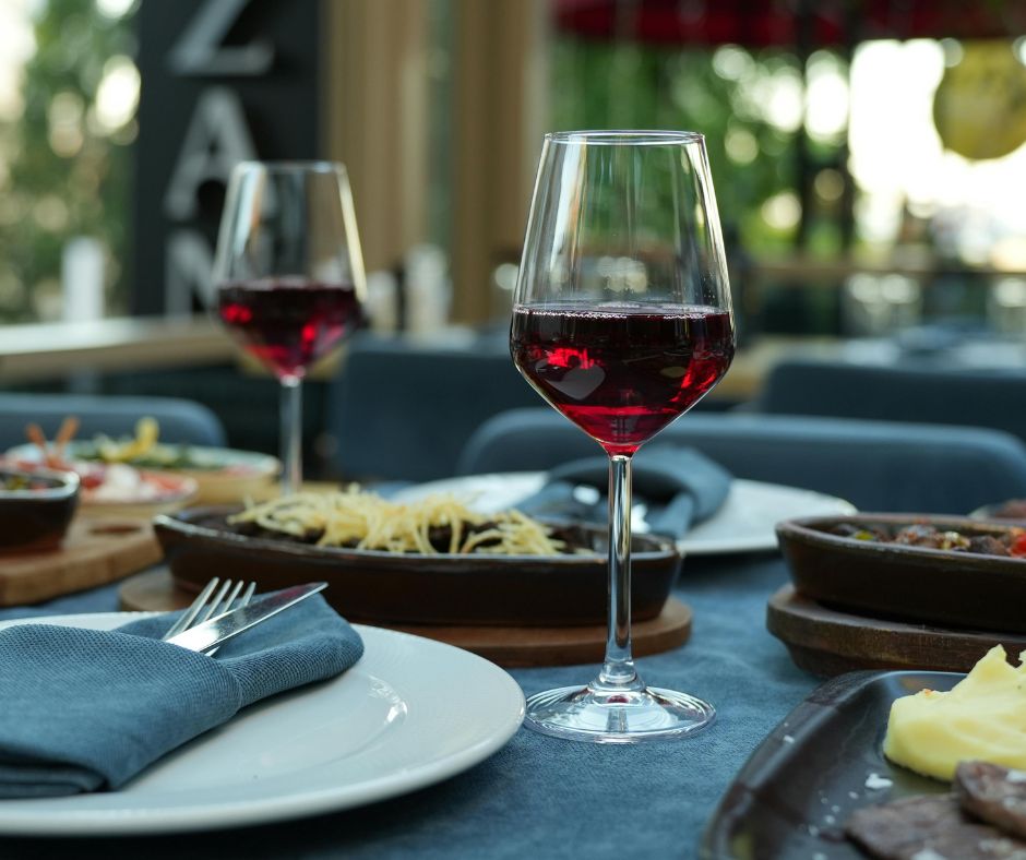 Who chooses the wine to drink at the restaurant?