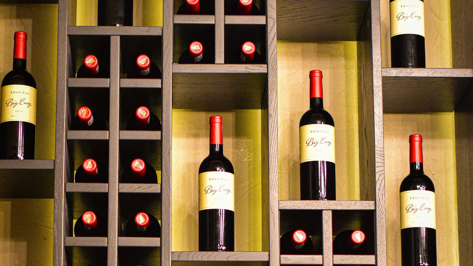 Why do wine bottles have longer necks than other beverages?