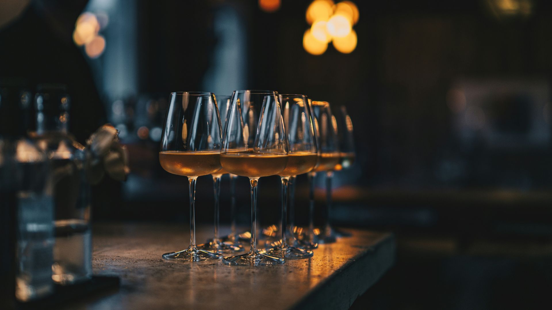 Why do we tap the table with the glass before drinking?