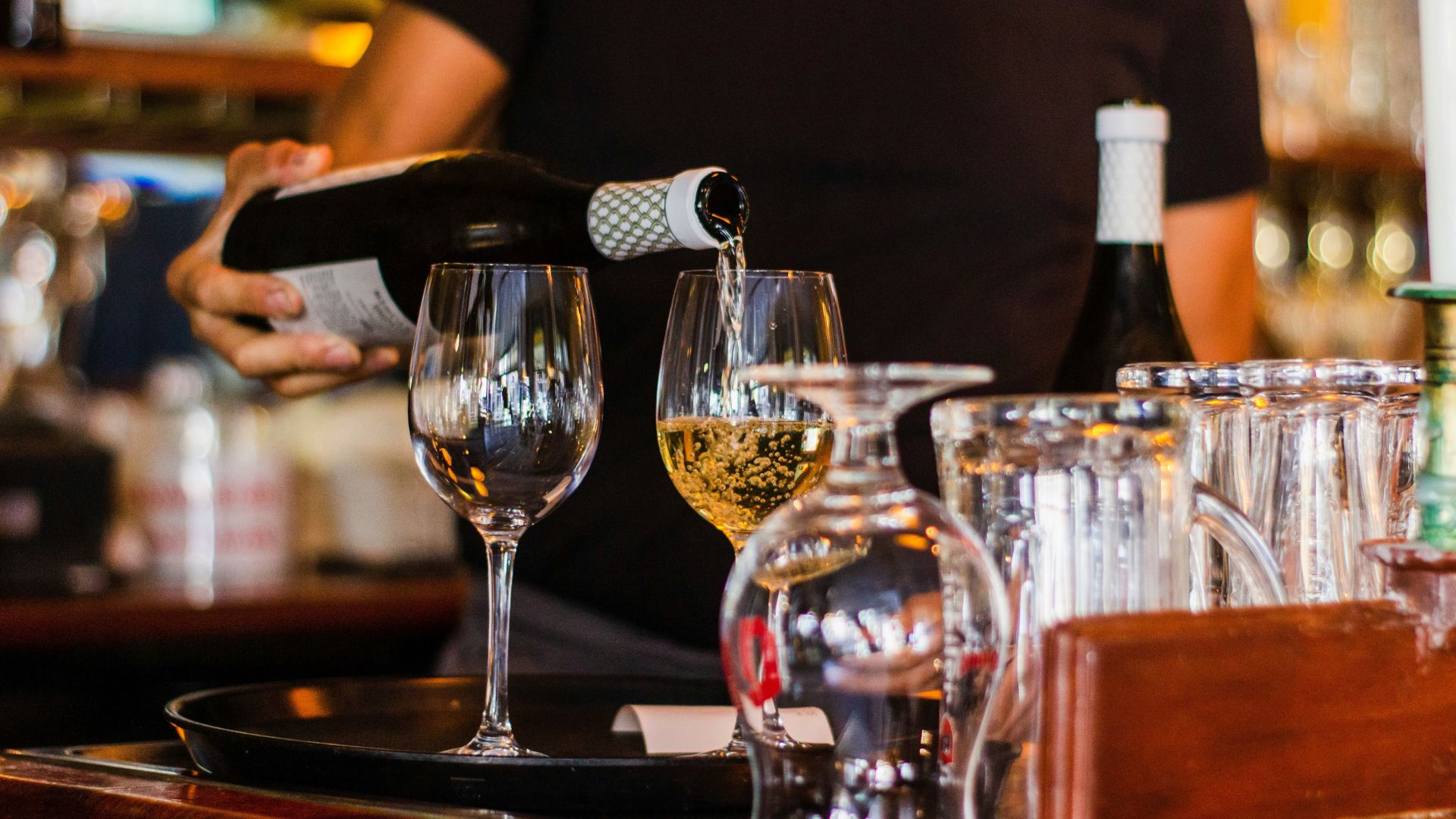 Why do we tap the table with the glass before drinking?