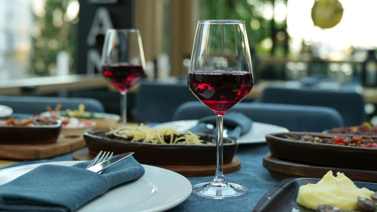 Who chooses the wine to drink at the restaurant?