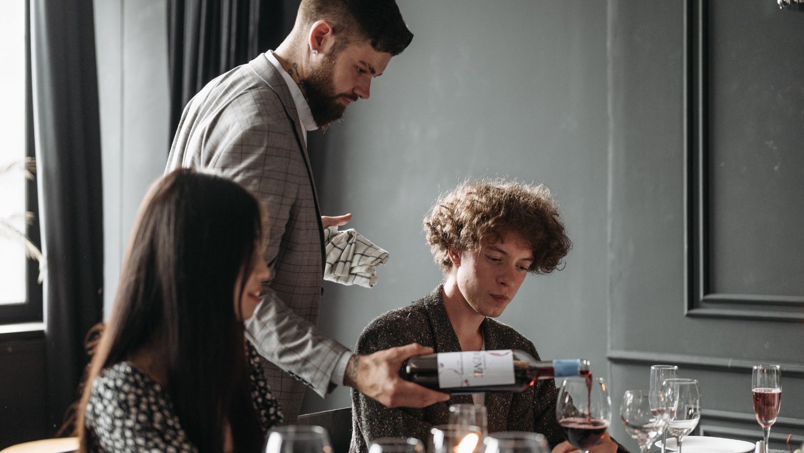 Should the wine be poured first for the person who has already tasted it?
