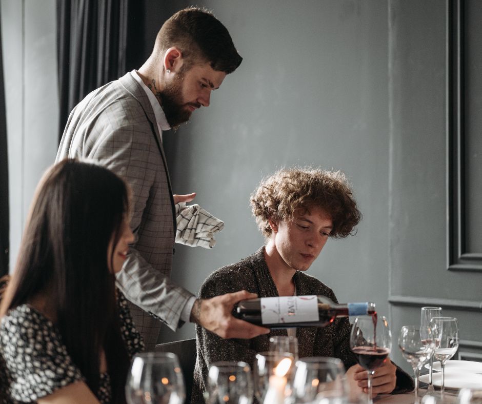 Should the wine be poured first for the person who has already tasted it?